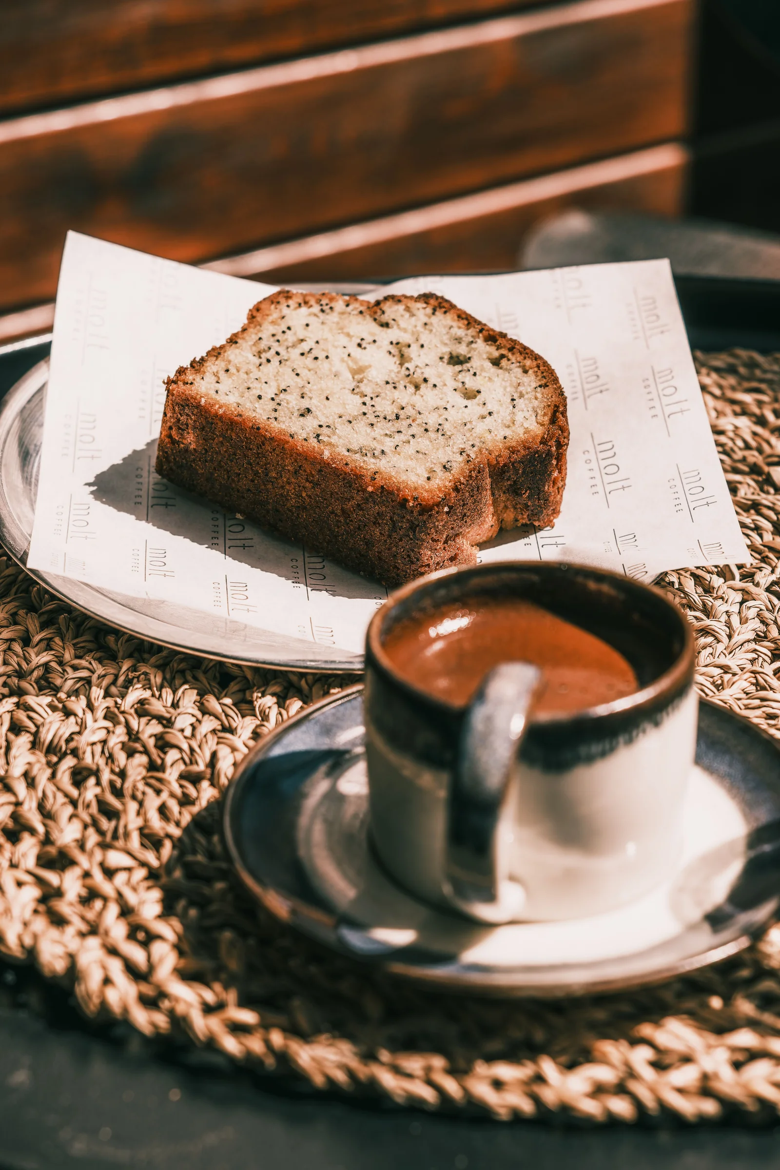 Rotating bakes: a slice of banana bread beside a cup of coffee