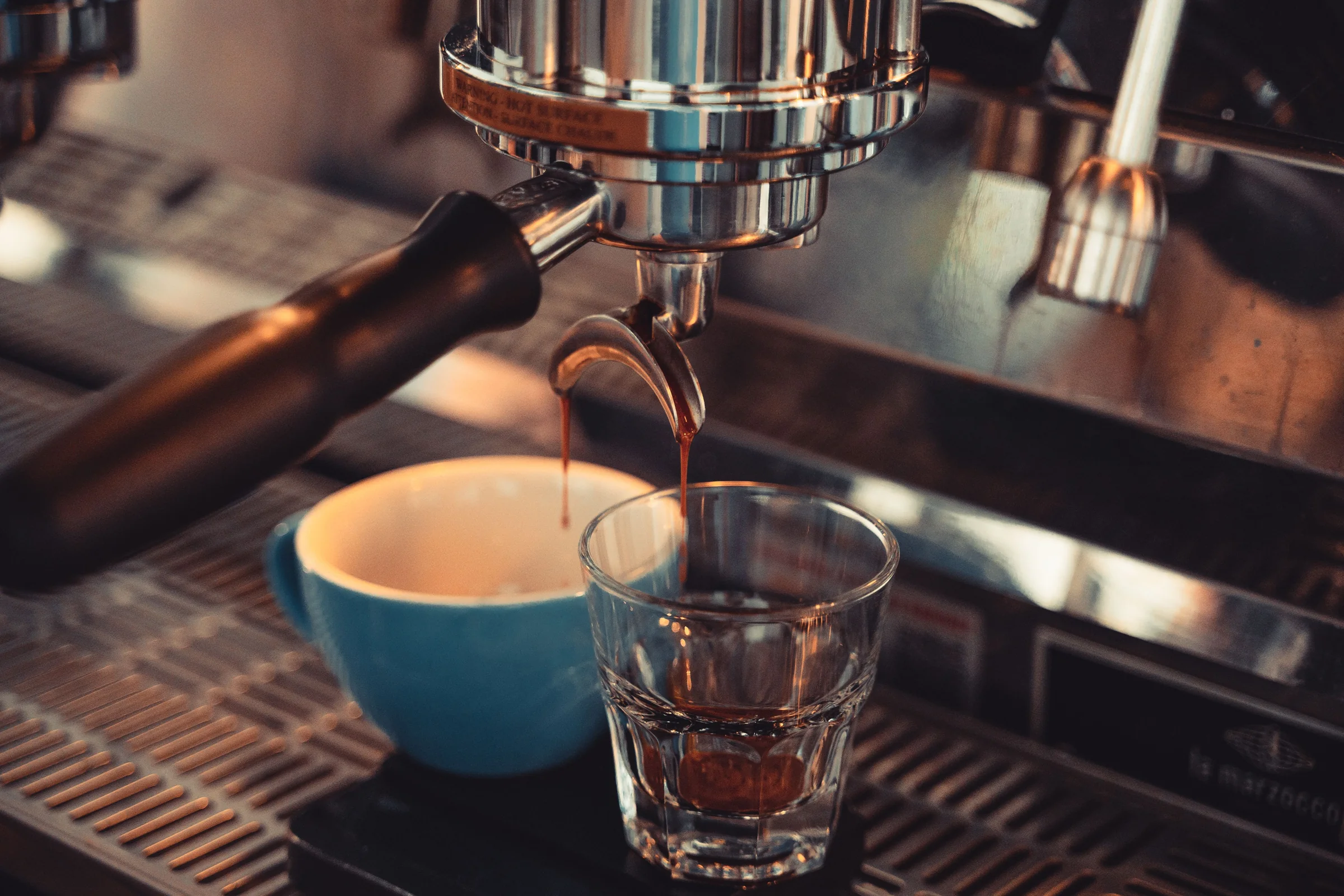 Espresso, Americano, latte: espresso pouring from a portafilter into a small glass
