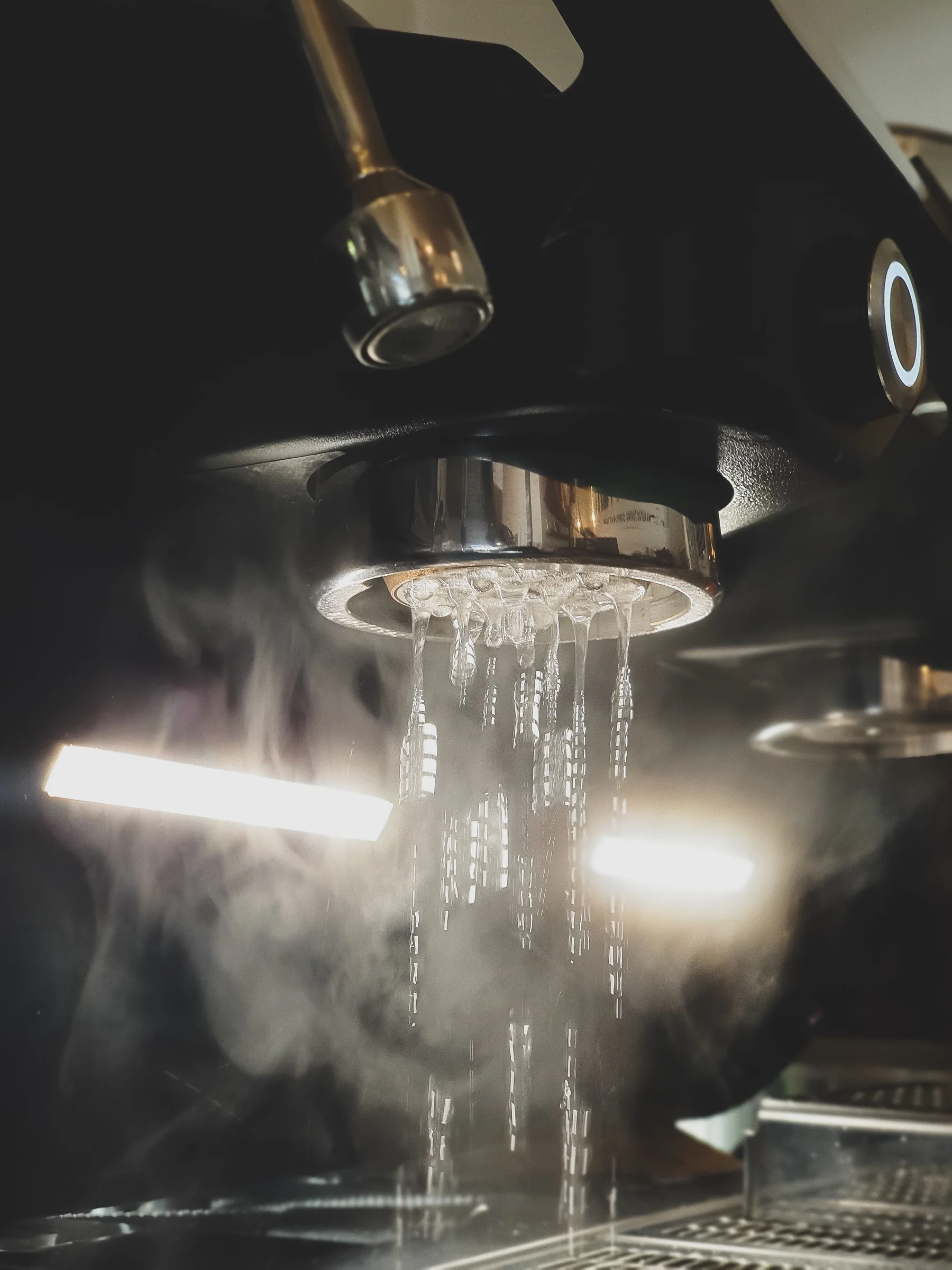 Steam and espresso: steam flowing from an espresso machine group head